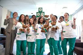 A group of smiling health care workers give the two-fingered Hawaiian "hang loose" sign. Some of them might make ideal foster parents, especially for children with medical needs.